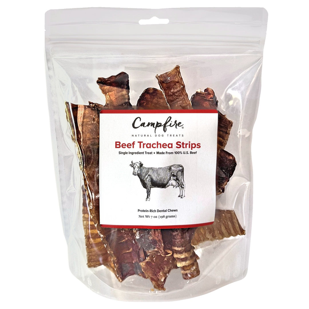 A pile of dehydrated beef trachea strips for dogs on a solid white background.